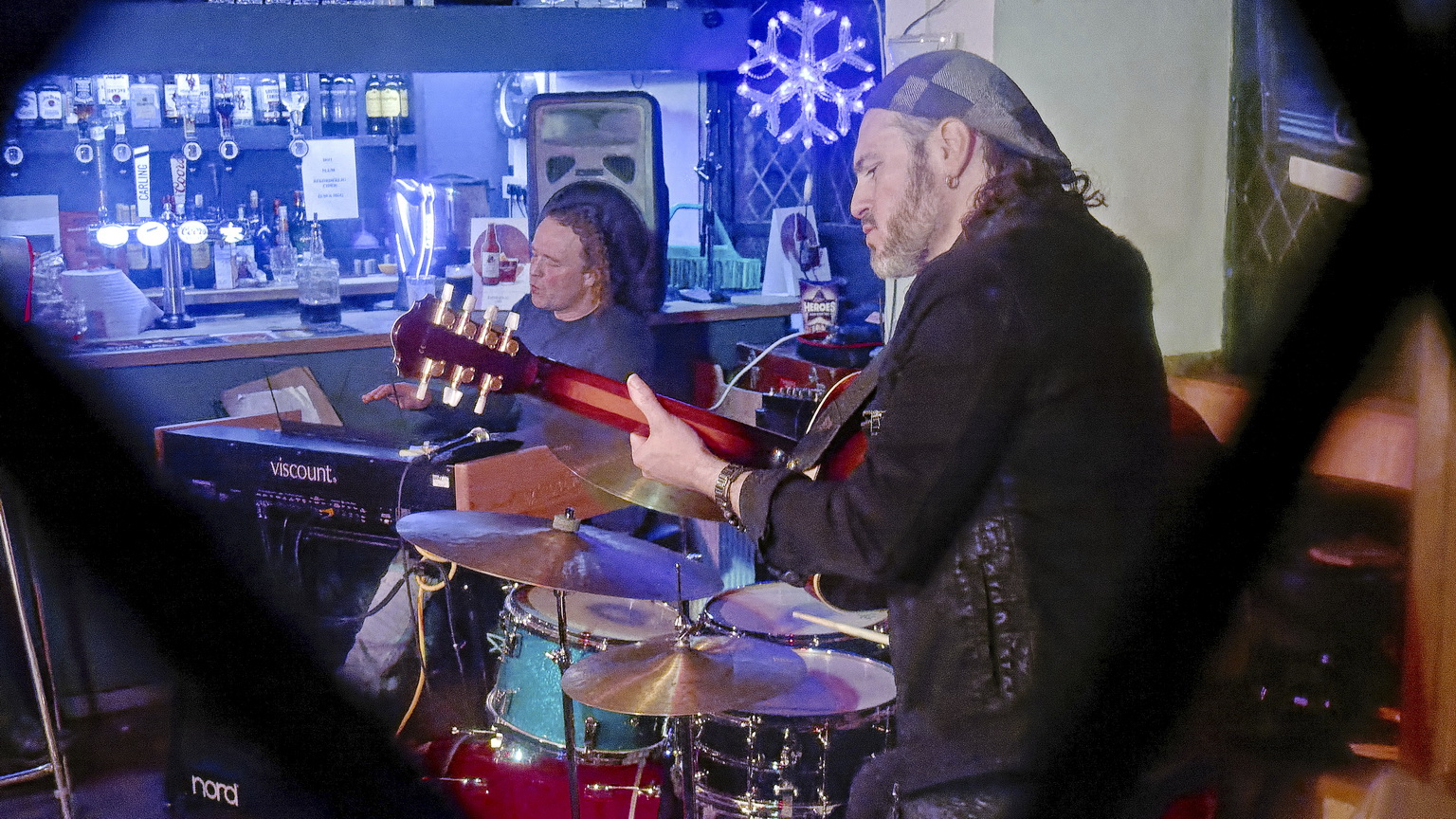 John Paul Gard Xmas Gig at Monmouth's Queen's Head seen from the street through the leaded lights